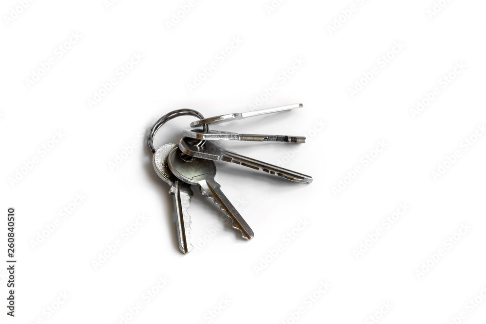 Several keys on a white isolated background,the keys to the apartment. Several keys on a white isolated background,the keys to the apartment.