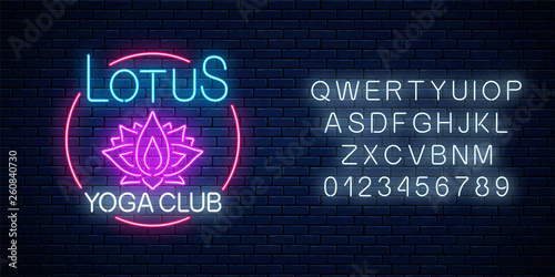 Neon glowing sign of lotus yoga club in circle frame with alphabet. Street lights signboard of chinese gymnastics.