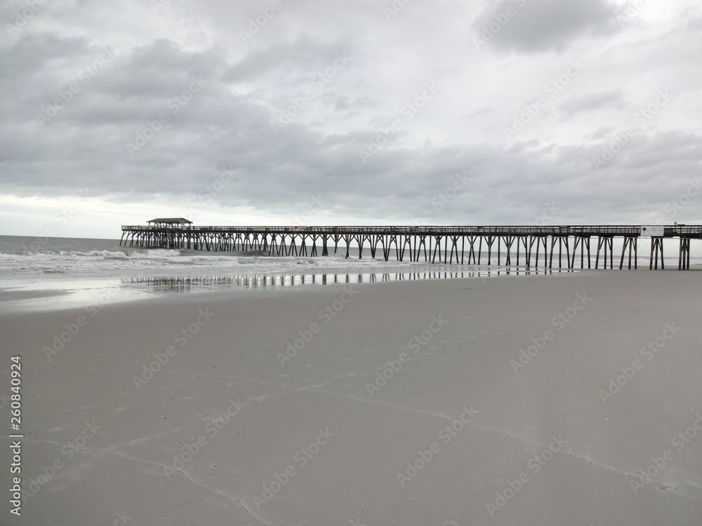 MYRTLE BEACH, SC/USA – CIRCA MAY 2015 – Waves beat against the pier at Myrtle Beach State Park as Tropical Storm Ana forms in the warm Atlantic waters.