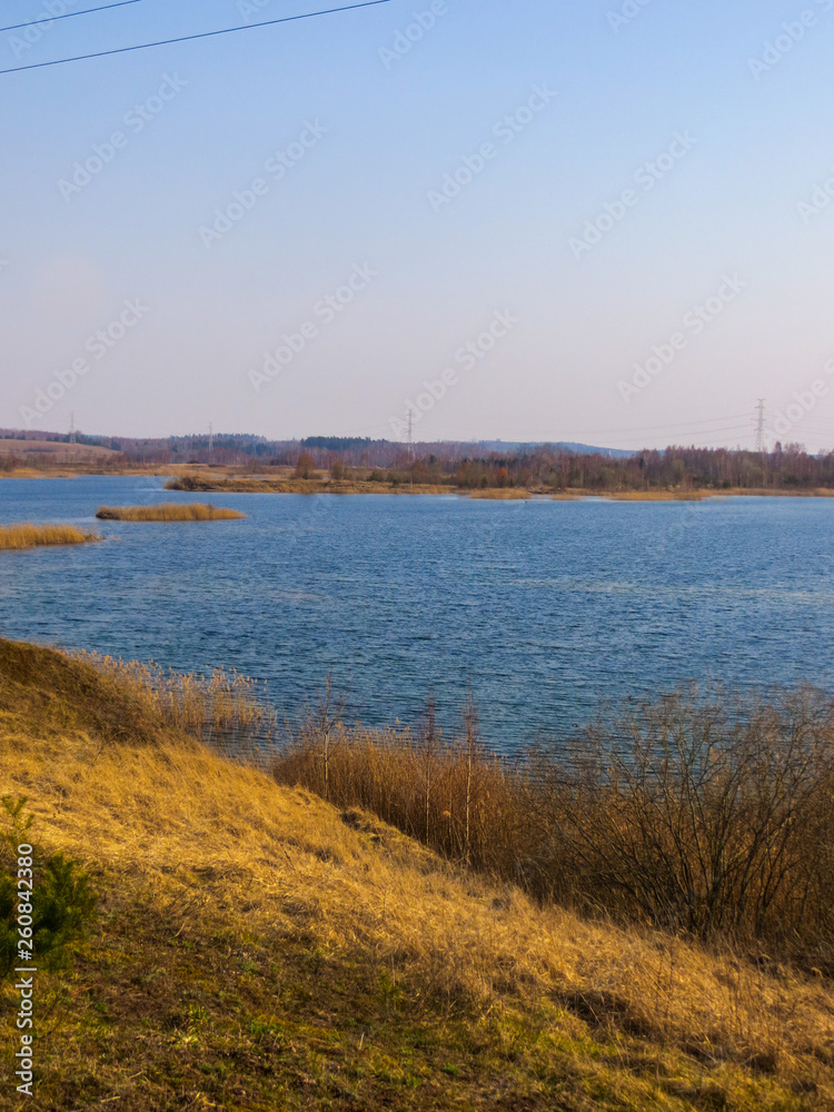 Beautiful view of the lake with blue water in Latvia. Spring landscape.