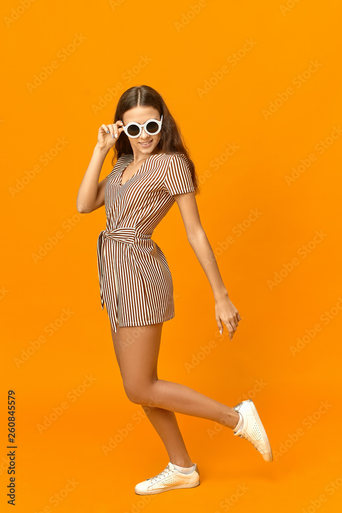 chic girl in bright glasses and jumpsuit poses near the car 16344072 Stock  Photo at Vecteezy