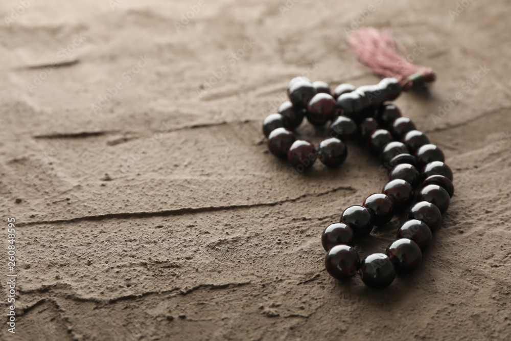 Prayer beads on brown background, space for text Prayer beads on brown background, space for text