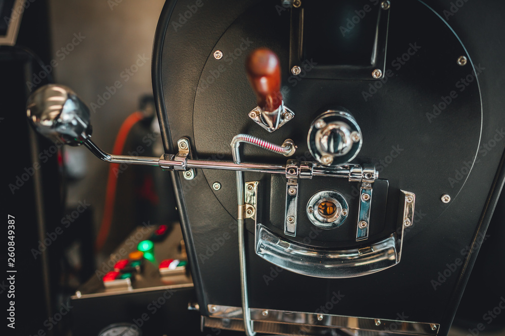 Fototapeta premium Coffee roasting in small roastery. Coffee roasting machine, Production of coffee.