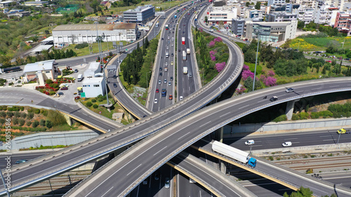Aerial drone view of popular highway multilevel junction road, passing through National motorway in traffic jam
