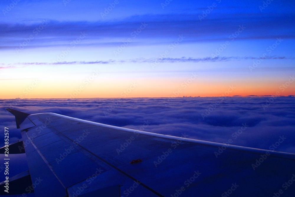 Sunrise from the airplane, high above clouds Sunrise from the airplane, high above clouds