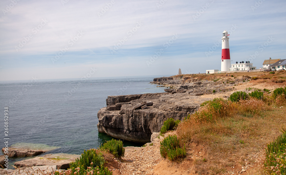 Lighthouse on a cliff looking out to sea on a clear day