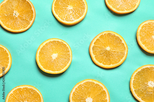 Flat lay composition with orange slices on color background
