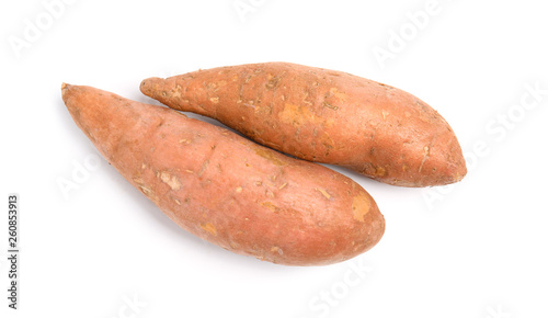 Whole ripe sweet potatoes on white background, top view