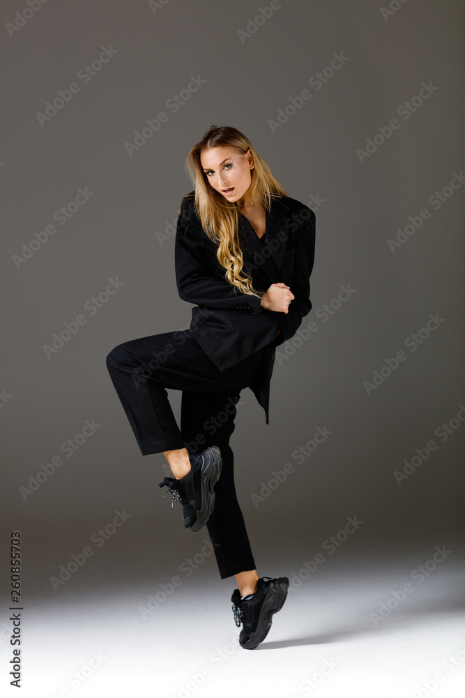 Young beautiful female dancer is posing in the studio Young beautiful female dancer is posing in the studio