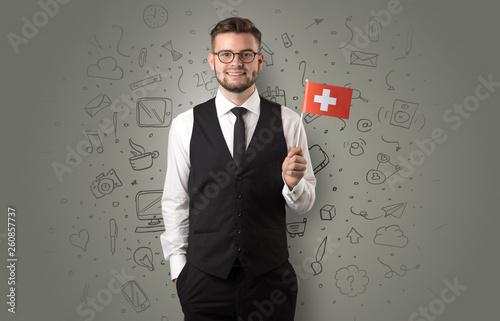 Businessman with office symbol concept and little flag on his hand
