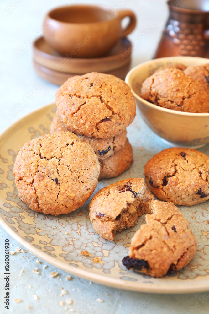 Healthy pastry. Homemade oatmeal cookies with dried cranberries and coffee in cerve Healthy pastry. Homemade oatmeal cookies with dried cranberries and coffee in cerve