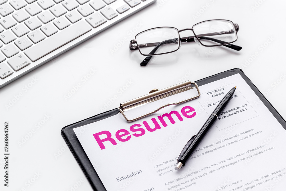 Review resumes of applicants set with keyboard and glasses white work desk background Review resumes of applicants set with keyboard and glasses white work desk background