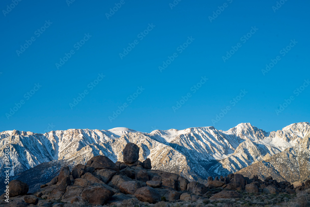 rock formations in front of snowy mountain peaks Sierra Nevada California Alabama Hills