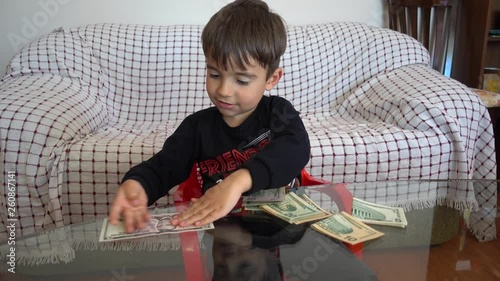 4K Child familiarizes with USA dollars paper money  photo