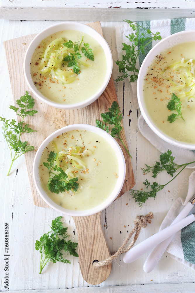 Cold summer zucchini cream soup, three portion on ligth bakground, vegetable food Cold summer zucchini cream soup, three portion on ligth bakground, vegetable food