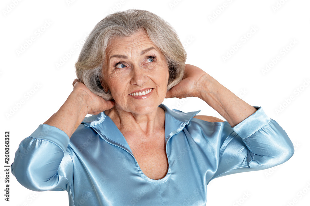 Portrait of beautiful senior woman in light blue blouse posing isolated on white background Portrait of beautiful senior woman in light blue blouse posing isolated on white background