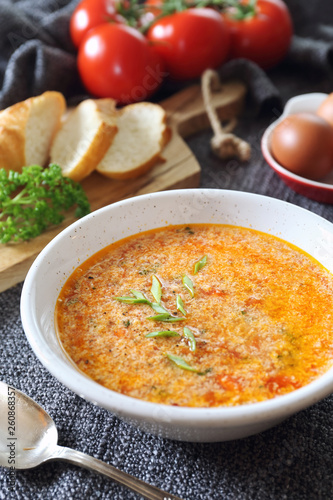 Italian cuisine. Stracciatella tomato soup: parsley, eggs and parmesan cheese