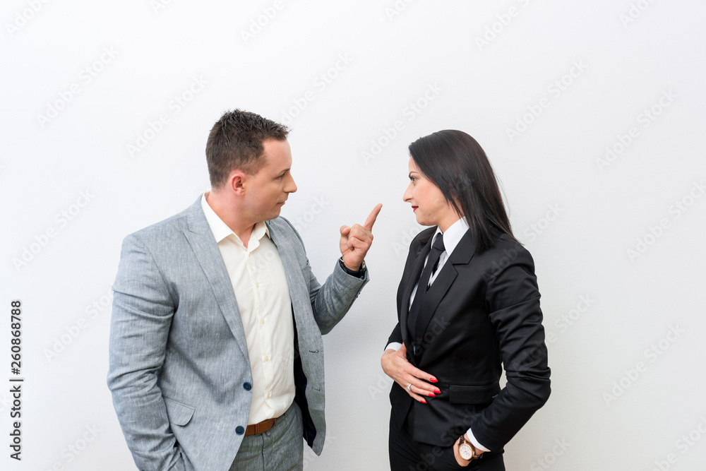 Two young attractive business man and woman having an argument. Two young attractive business man and woman having an argument.