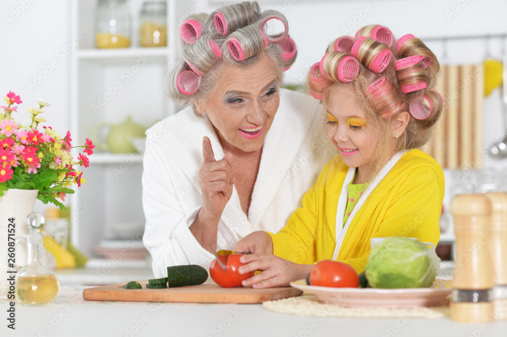 Portrait of senior woman and granddaughter at kitchen Portrait of senior woman and granddaughter at kitchen