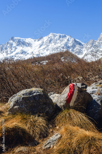 Mountain hiking path trough the massif of the Monte Rosa (Piedmont, Italy) to the Sella refuge, walked at the end of winter, with white and red tracks