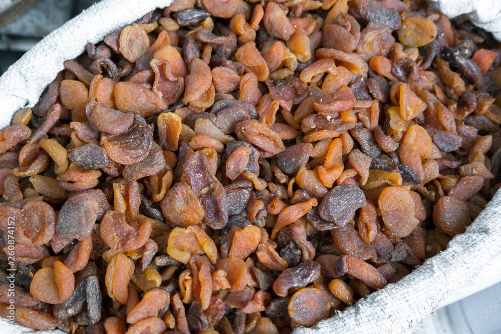 Naturally dried apricot fruit in the sun. organic dried apricots sold in sacks Naturally dried apricot fruit in the sun. organic dried apricots sold in sacks