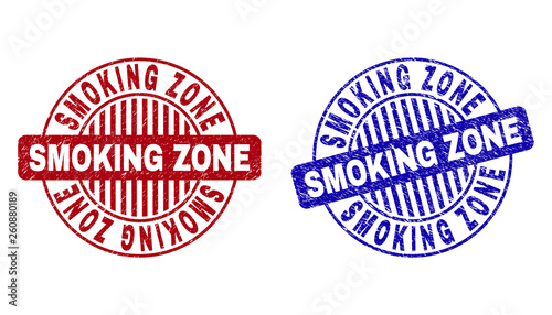 Grunge SMOKING ZONE round stamp seals isolated on a white background. Round seals with grunge texture in red and blue colors.
