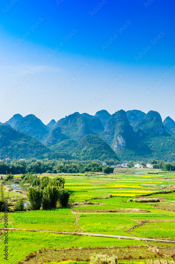 Countryside and mountain scenery with blue sky background 