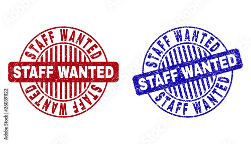 Grunge STAFF WANTED round stamp seals isolated on a white background. Round seals with grunge texture in red and blue colors.