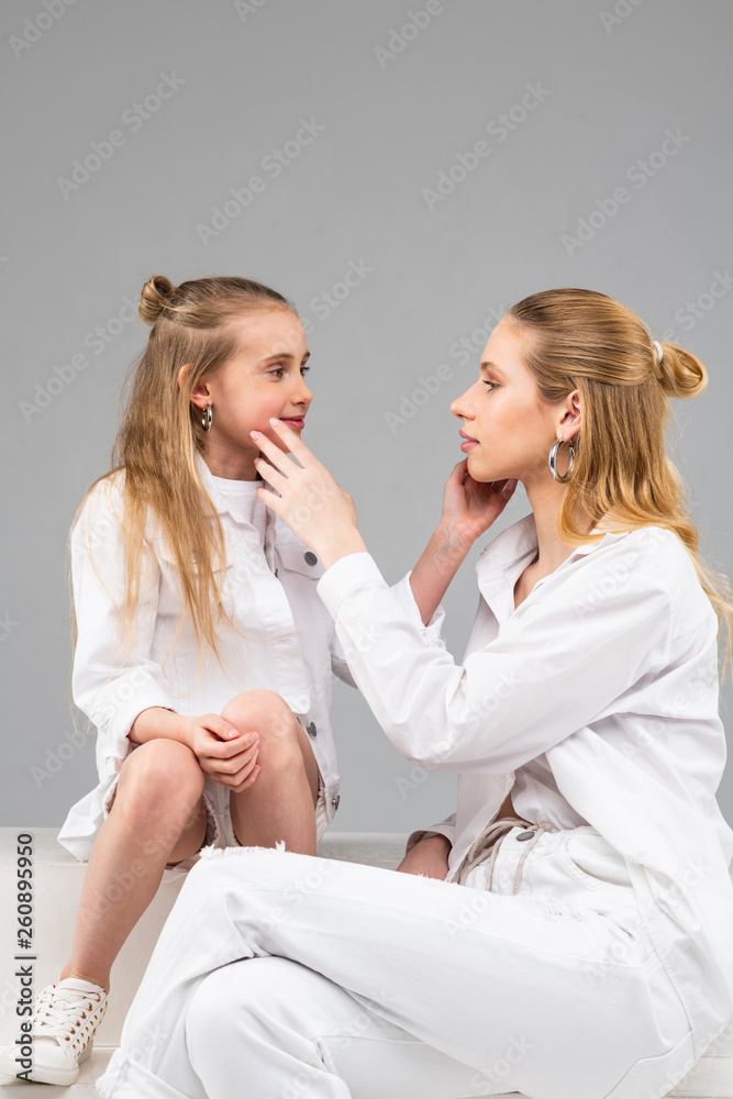 Tall long-haired woman with silver jewelry and white clothes observing Tall long-haired woman with silver jewelry and white clothes observing