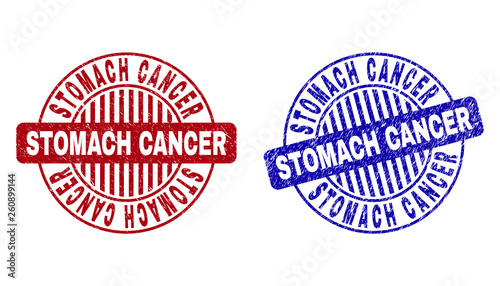 Grunge STOMACH CANCER round stamp seals isolated on a white background. Round seals with grunge texture in red and blue colors.