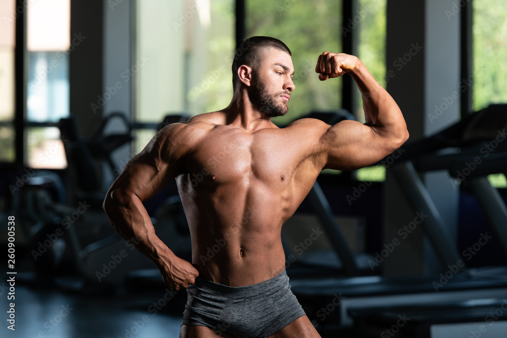 Muscular Man Is Hitting Bicep Pose
