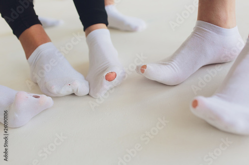 Hole in gray sock shows big female toe.