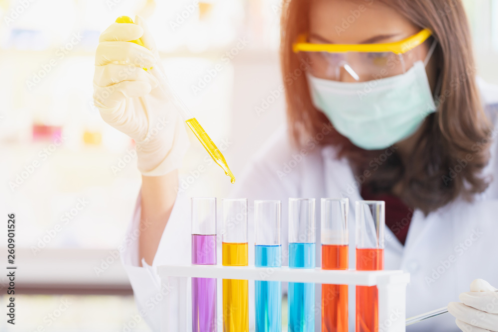 Scientist dropping liquid to petri dish.. Scientist dropping liquid to petri dish..
