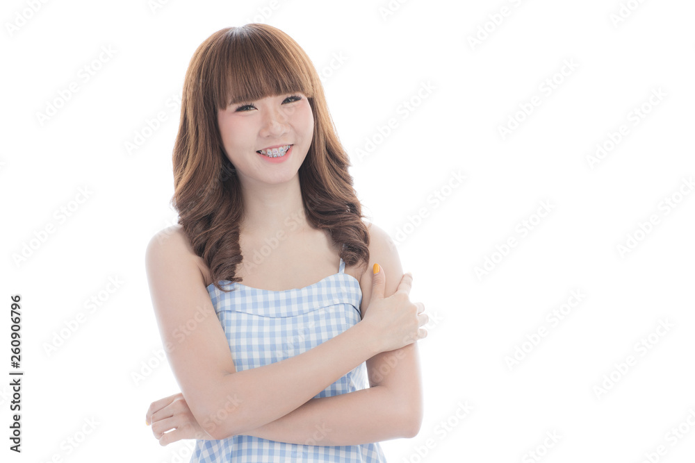 Front view close-up portrait of young beautiful Asian woman with curly long dark brown hair in light blue checked dress stand up straight isolated white background Front view close-up portrait of young beautiful Asian woman with curly long dark brown hair in light blue checked dress stand up straight isolated white background