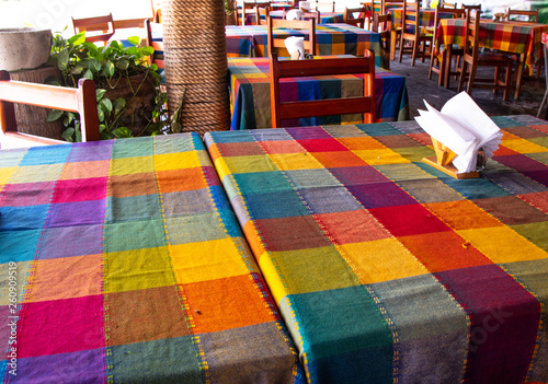 Bright colorful checkered table cloth in Mexican restaurant.