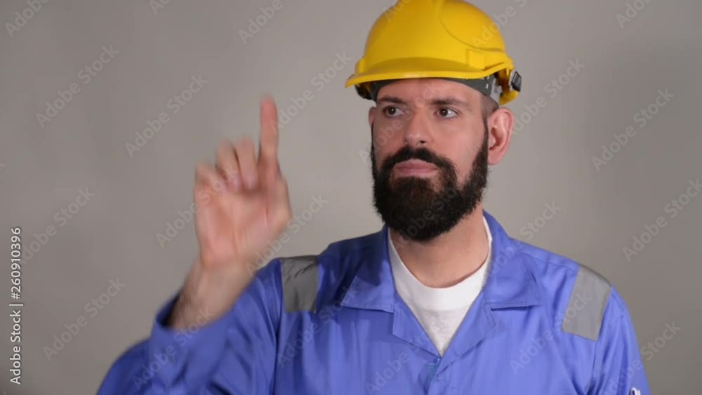 Bearded man builder in helmet ready to write something by finger. Bearded man worker with beard in building helmet or hard hat Bearded man builder in helmet ready to write something by finger. Bearded man worker with beard in building helmet or hard hat