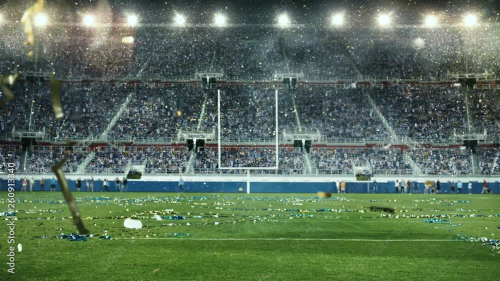 Huge Crowd celebrating victory in American Football generic stadium.  Night lights and confetti.