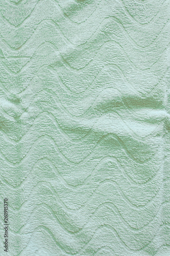 Top view of Green Towel texture. Green Towel Fabric Texture Background. Close-up. Green natural cotton towel background. Space for text. Hygiene, fabric, laundry,spa and textile concept.