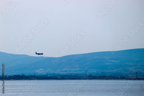 Plane landing to Thessaloniki airport Makedonia at clear weather above the mediterranean sea