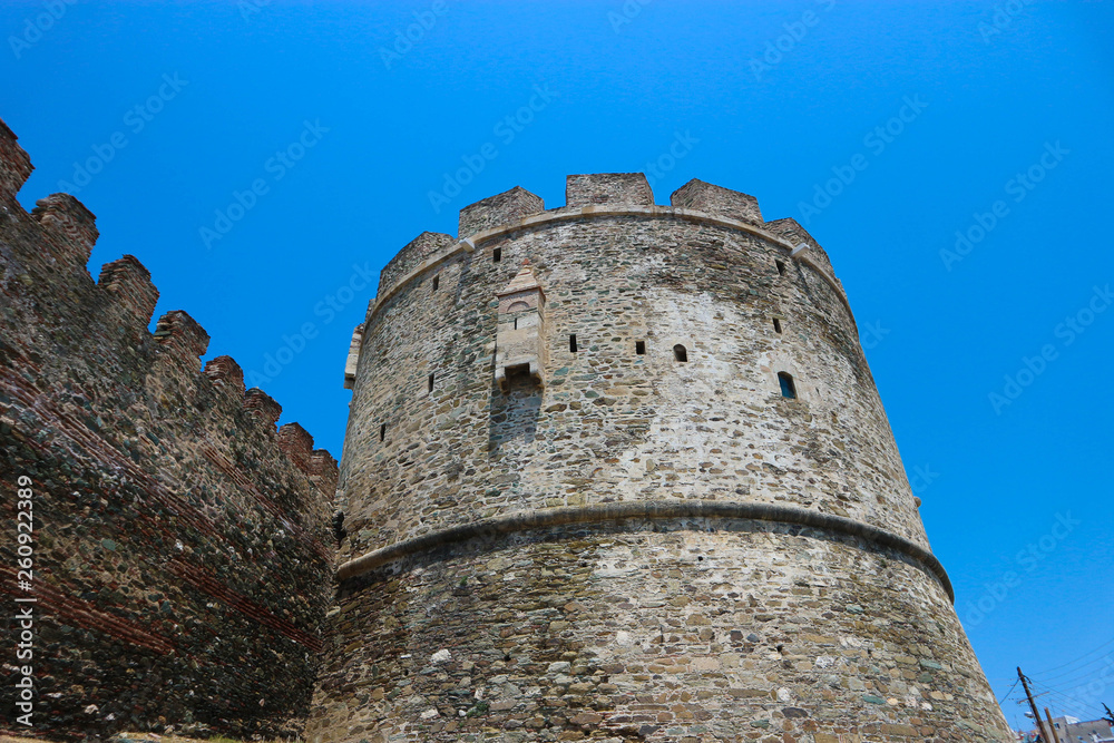 Tower of Trigonion (Alysseos Tower), part of Byzantine fortifications in Thessaloniki, Greece against bright blue sky