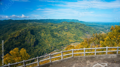 see beautiful scenery from the top of a green hill