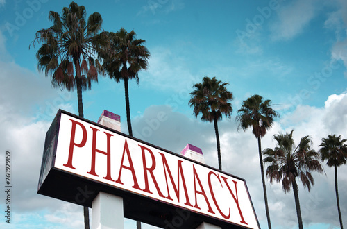 aged and worn pharmacy sign with palm trees © jdoms
