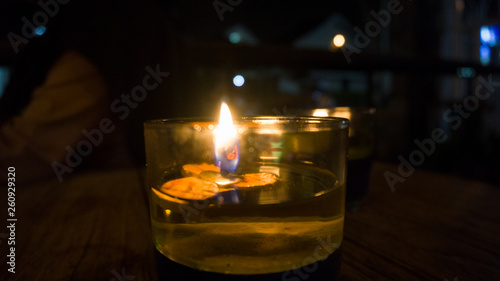 candles in a glass on a wooden table