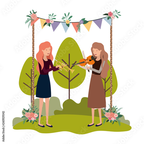 women with musical instruments in landscape