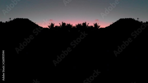 Mirror palm beach Philippines by sunset
