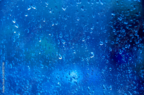 dark blue Texture Raindrops on window glass for rain, photo, blurred background, drizzle