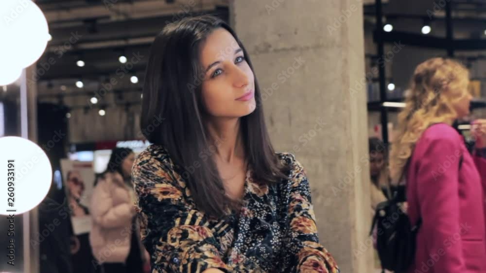 Beautiful girl looks in the mirror and admires herself Beautiful girl looks in the mirror and admires herself