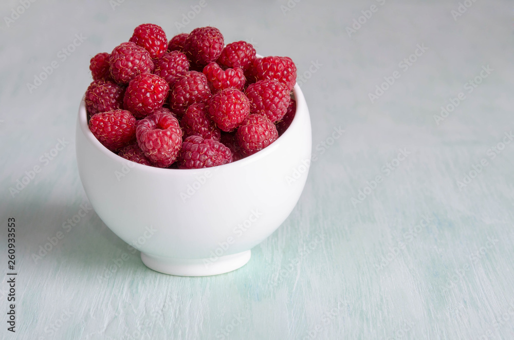 ripe raspberry in white bowl on the table ripe raspberry in white bowl on the table