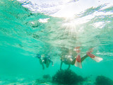 couple snorkeling in crystal clear tropical waters