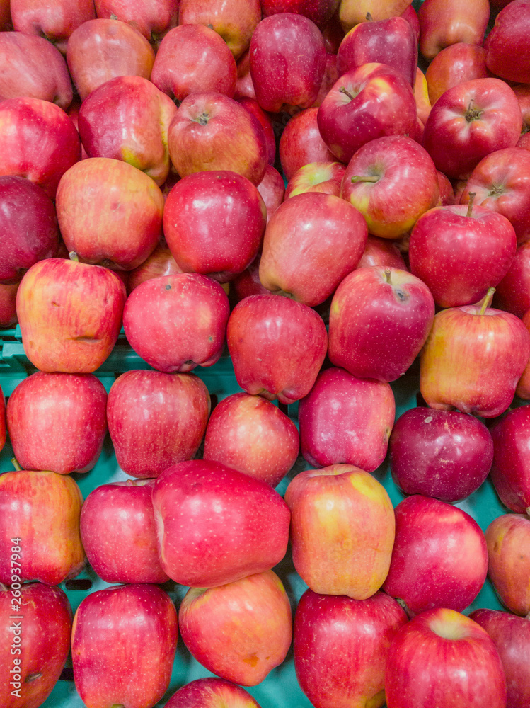 Many beautiful red apples in a box in a supermarket Many beautiful red apples in a box in a supermarket